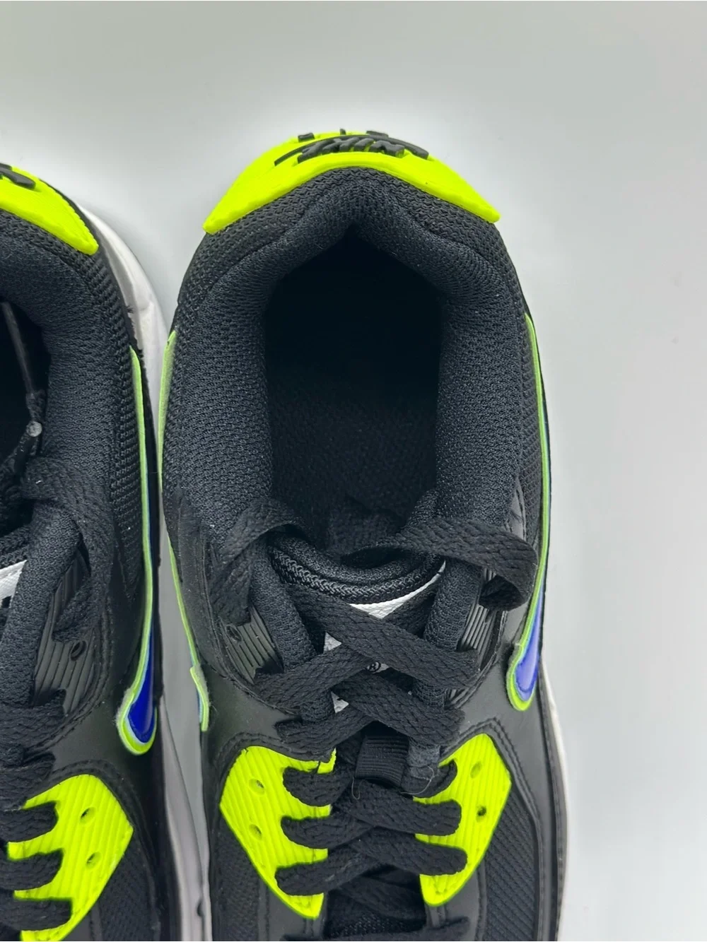 Nike Kids Black Sneakers with Neon Yellow and Blue Swoosh